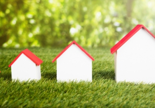 series of model houses of different sizes on grass